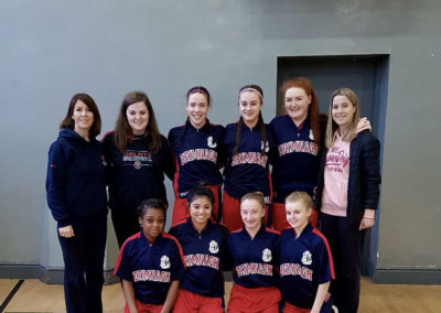 Basketball team with coaches Ms Hall and Ms Moran